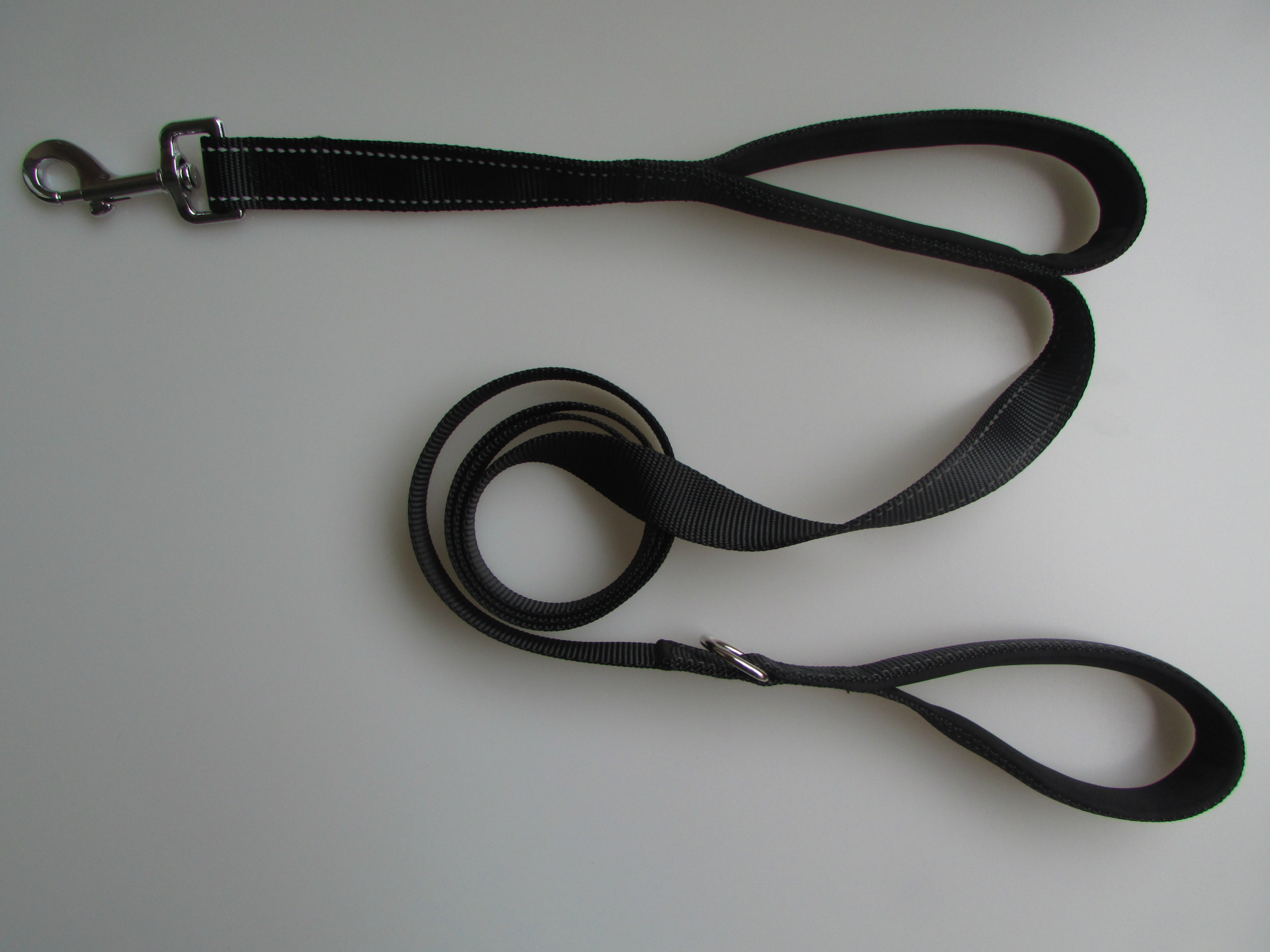 Dog walker using the standard handle on the black leash.