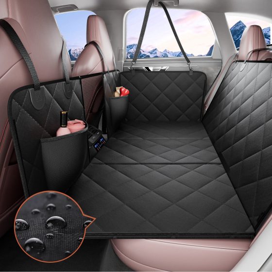 A black quilted hard-bottom seat extender installed across a vehicle rear seat, with straps, mesh panel and pockets.